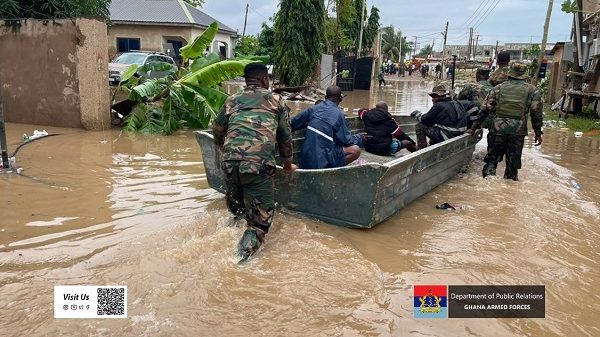 Flooded streets in Accra with emergency teams rescuing residents during heavy rainfall