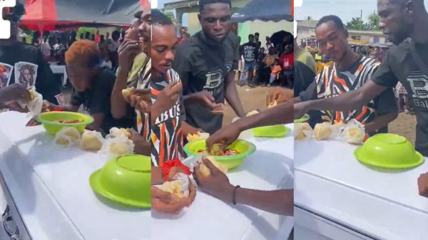 Friends eating banku and okro soup placed on a coffin during a funeral ceremony in Apam, Ghana