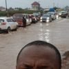 Flooded road in Accra as motorists navigate rising floodwaters following heavy rainfall on Monday.
