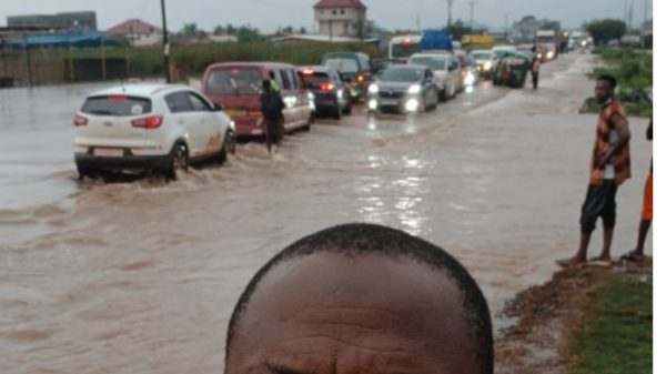 Flooded road in Accra as motorists navigate rising floodwaters following heavy rainfall on Monday.