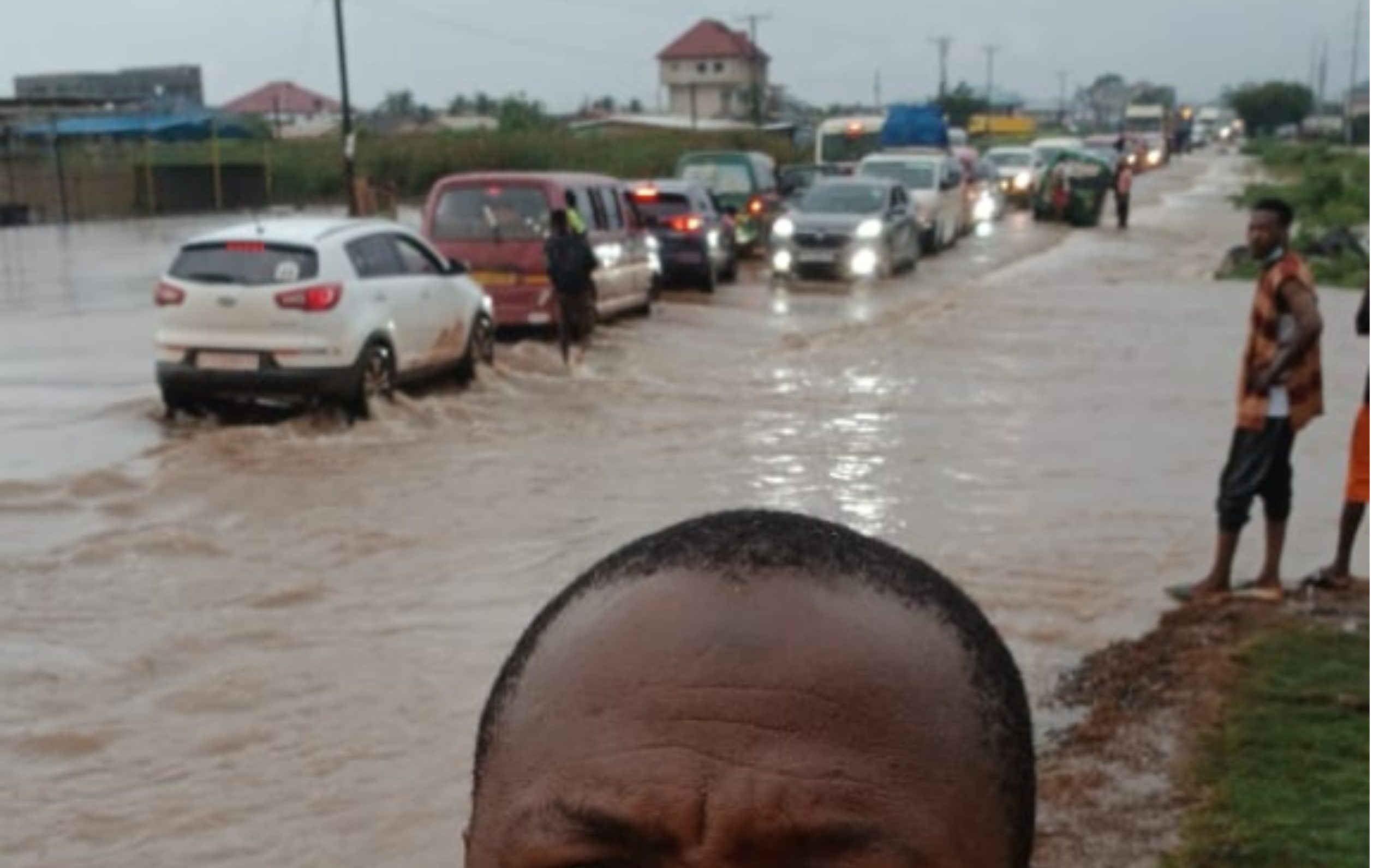 Flooded road in Accra as motorists navigate rising floodwaters following heavy rainfall on Monday.