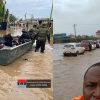Flooded streets in Accra with residents navigating deep water as vehicles struggle through heavy rainfall across multiple neighbourhoods