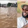 Flooded streets in Accra after heavy rains with stranded vehicles and commuters navigating waterlogged roads.