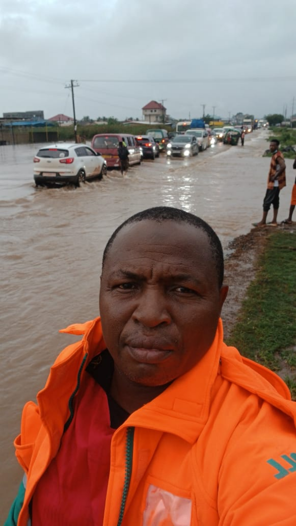 Floodwaters covering a major road in Accra as vehicles move cautiously following heavy rains on June 29, 2026.