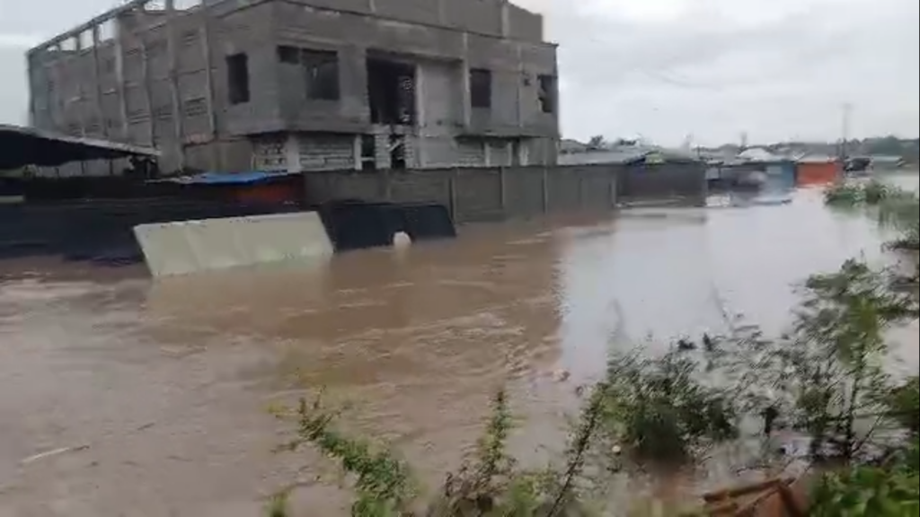 Floodwaters covering a major road in Accra as vehicles move cautiously following heavy rains on June 29, 2026.