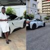 Abu Trica with luxury vehicles allegedly seized by US authorities during an investigation into an alleged $8m romance scam.