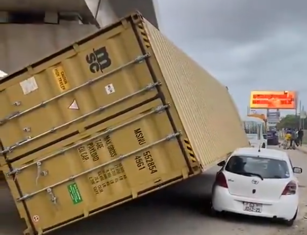 A shipping container resting on a crushed Toyota Vitz after falling off a moving truck near Junction Mall in Accra
