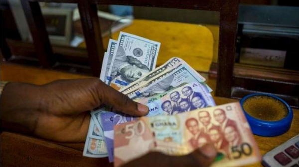 Ghana cedi banknotes with US dollar notes illustrating Ghana's latest foreign exchange market performance.