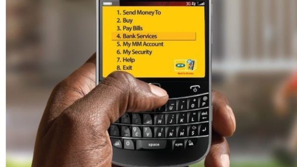Person using a mobile money app on a smartphone as INTERPOL warns of rising mobile money fraud in Ghana.